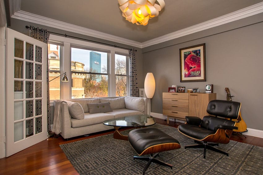 Room with Eames chair, wood side board and curtains 