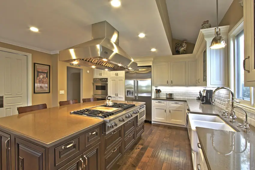 Kitchen with solid walnut floors, cabinets in white finish and taupe counters