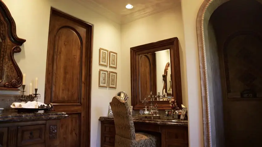 Makeup counter in master bathroom with decorative wood