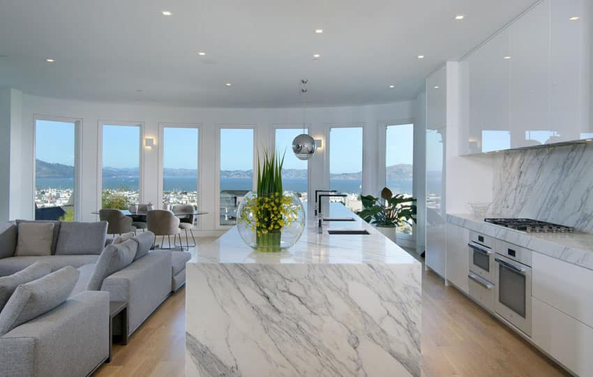 Kitchen with European cabinets, marble counter and wraparound windows