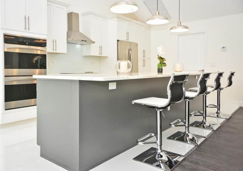 Modern white cabinet kitchen with gray island and metal bar stools