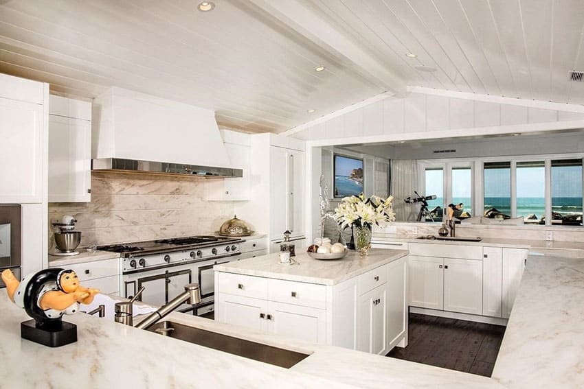 Oceanview kitchen with white cabinets and calacatta splendor marble counters