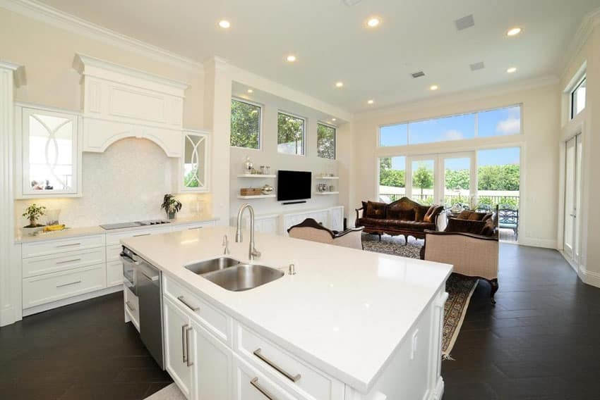 Open layout kitchen with white cabinets and super white quartz counter