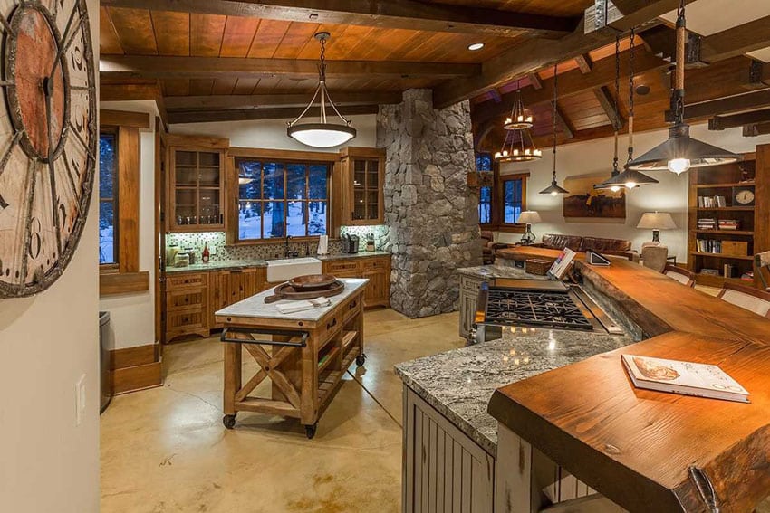 Kitchen with portable island and large masonry columns