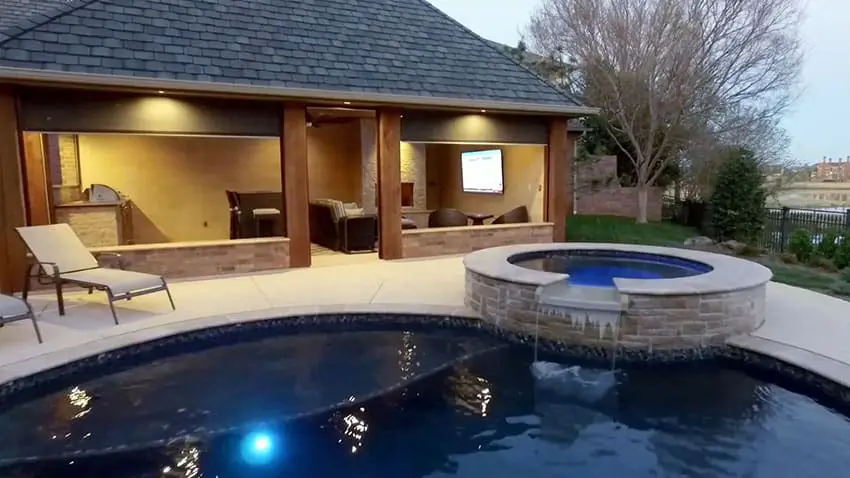 Swimming pool with cabana with motorized shades fireplace