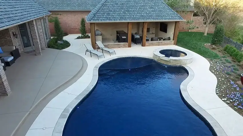 Swimming pool with travertine coping and luxury cabana