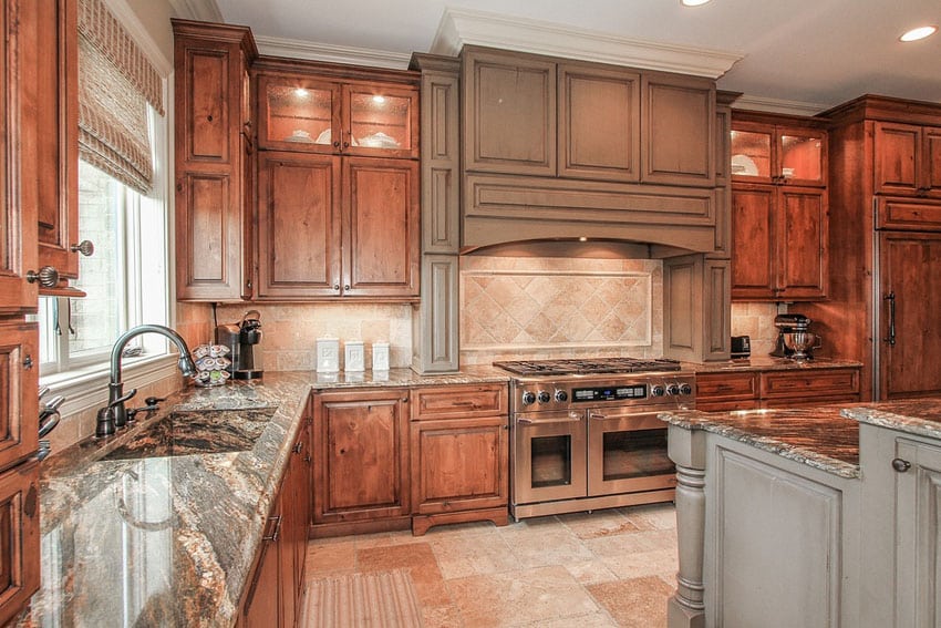Traditional kitchen with complex granite counters and rustic wood cabinetry