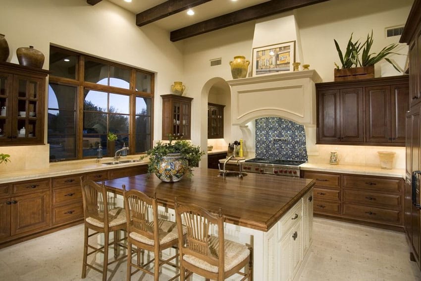 Traditional kitchen with raised cabinetry and butcher block dining island