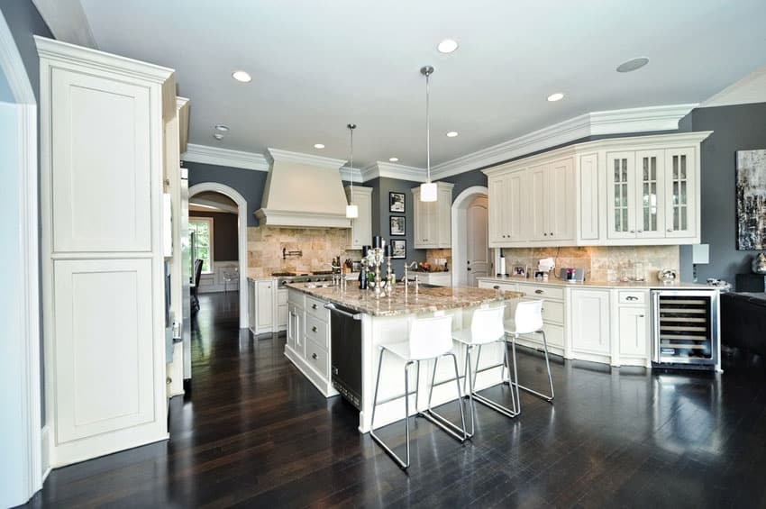 Traditional kitchen with white sand granite counters and white cabinets