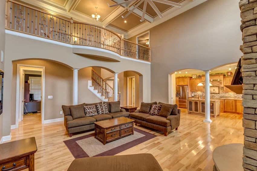 Room with hickory floors, white molding, brown walls and mezzanine floor
