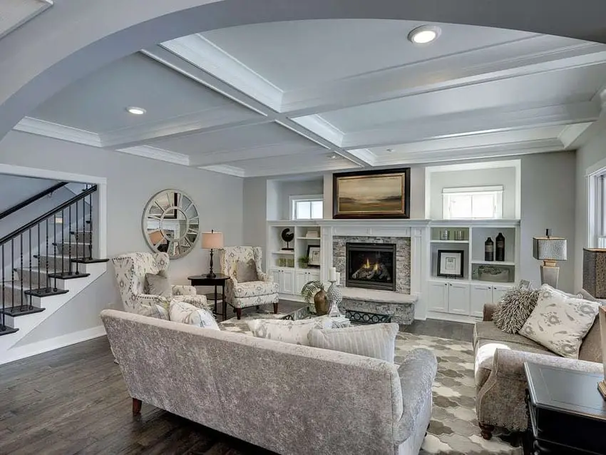 Transitional style room with light gray walls, wingback chairs and electic fireplace