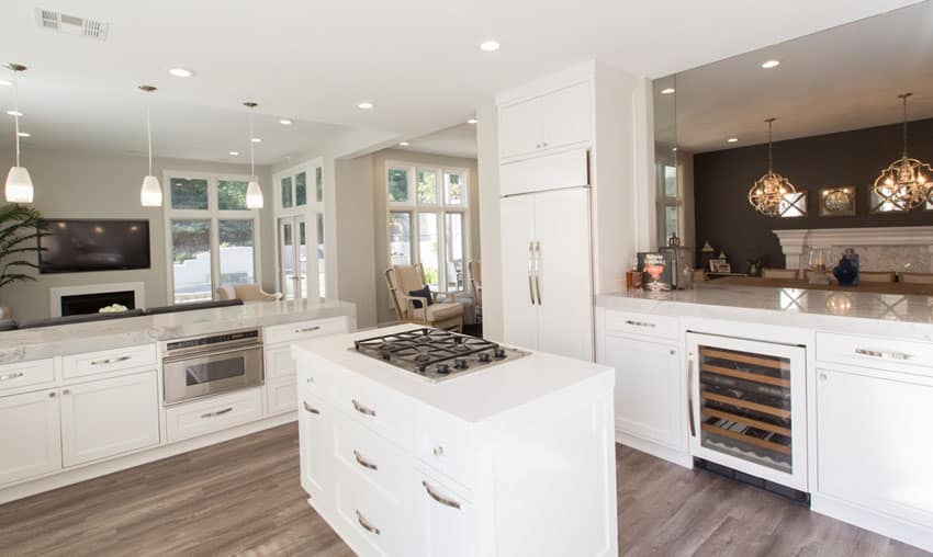 Transitional kitchen with white cabinets small island with stovetop wine fridge