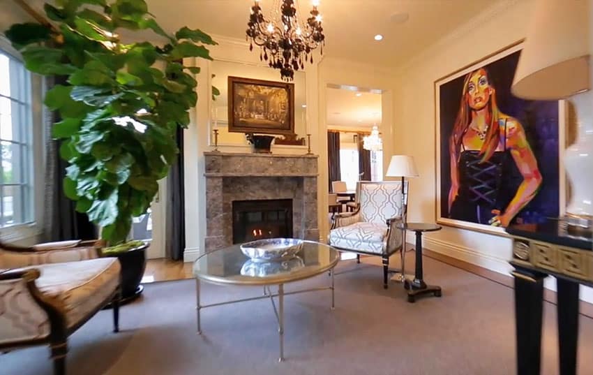 Upscale living room space with fireplace and art
