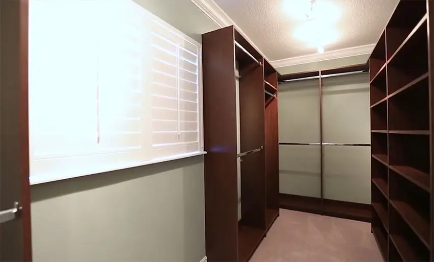 Walk in closet with plantation shutters