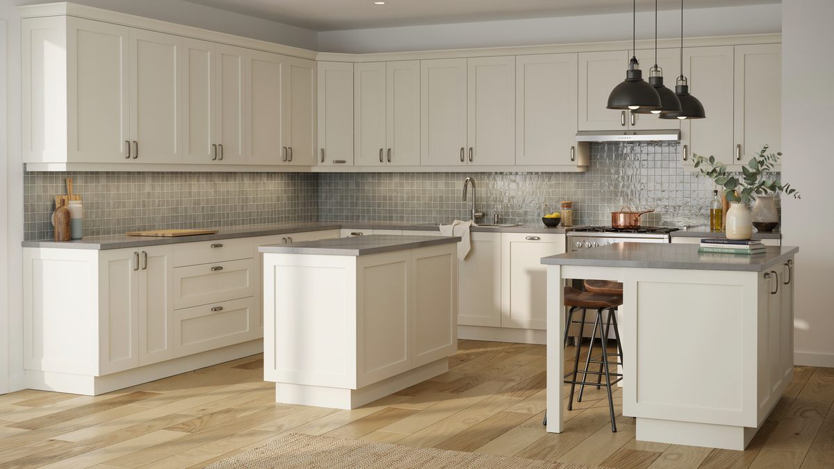 Off white paneled cabinets with gray counters and green glass mosaic backsplash
