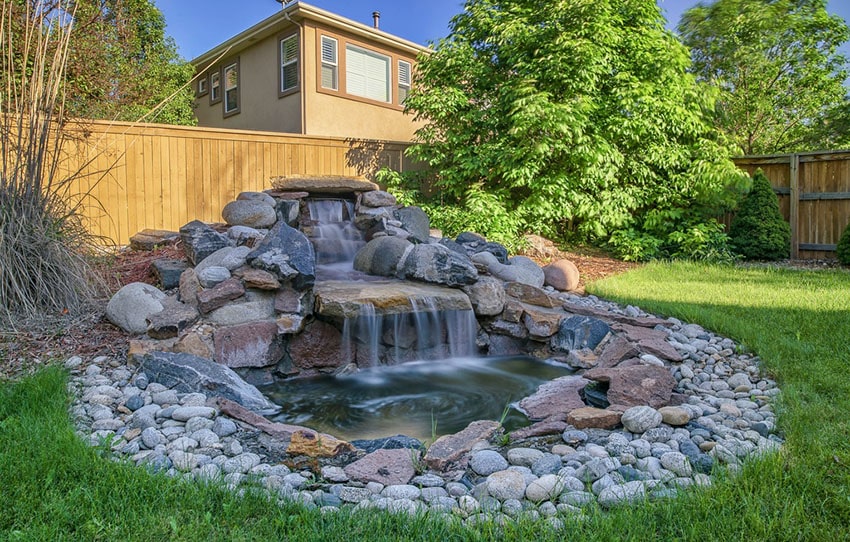 Backyard stone water feature waterfall