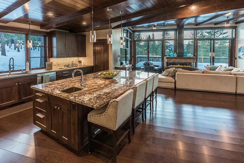 Kitchen with wet bar, pendant lights and view of the living room with white sectional