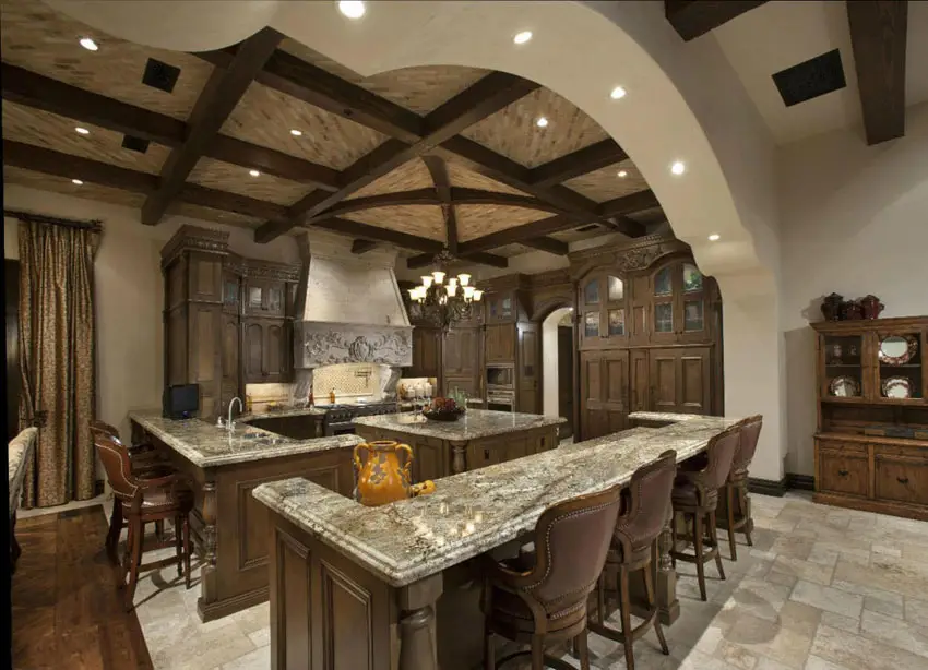 Kitchen with long dining island and limestone floors