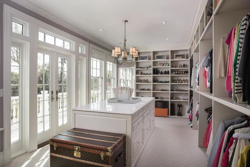 Beautiful white walk in closet with french doors and large island
