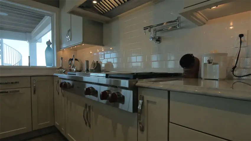 Close up view of stove gourmet kitchen with subway tile