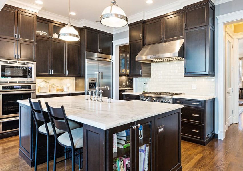 Kitchen with dark wood cabinets and white Calacatta marble countertops