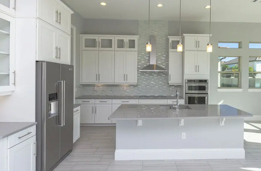 Kitchen with white cabinets and adhesive mosaic backsplash