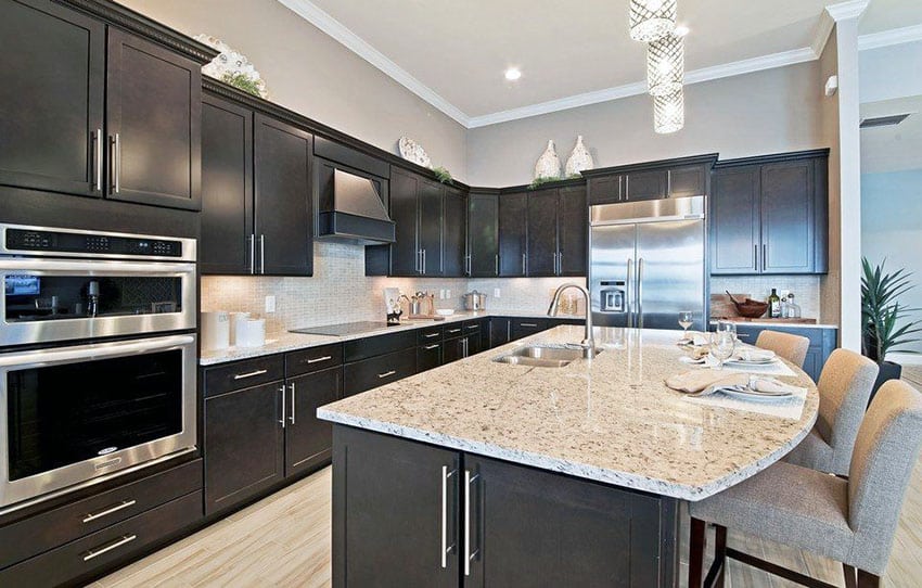 Contemporary kitchen with dark European cabinets, gray painted walls and light granite countertops
