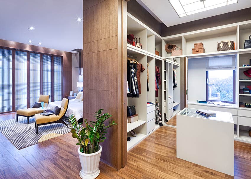 Contemporary walk-in closet with island and skylight