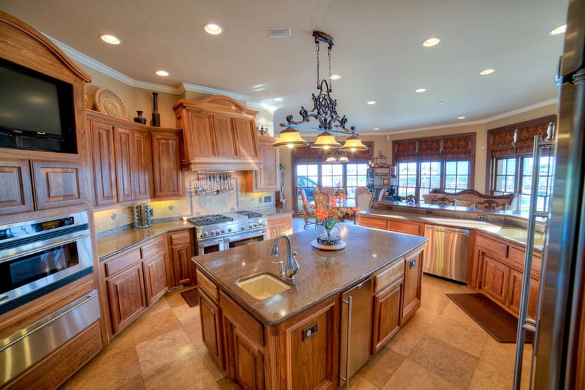 Craftsman kitchen with custom hood and cabinets with granite counters