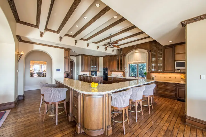 Kitchen with Neoclassic deisgn elements, arched entryway and wood beadboard flooring
