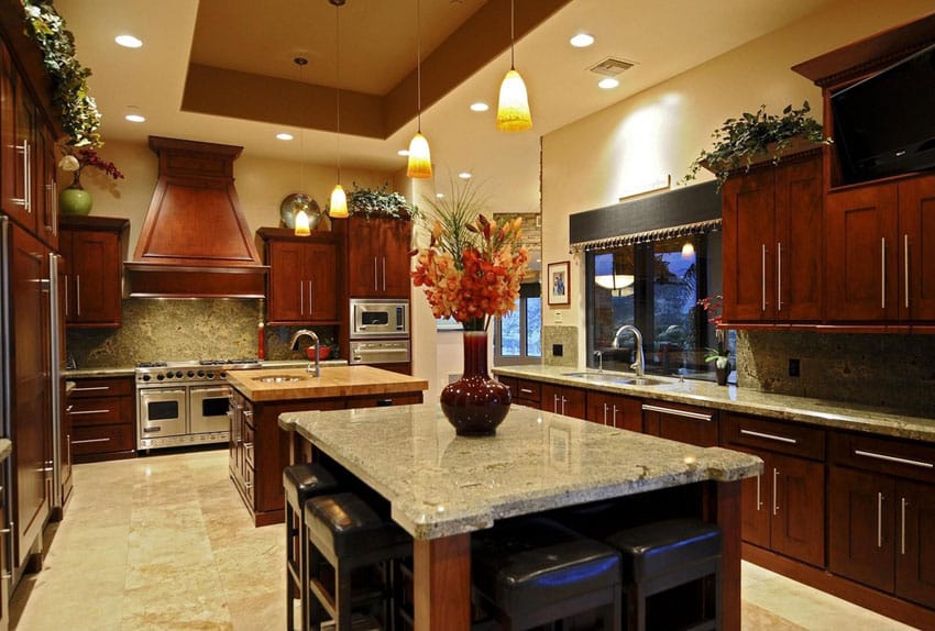 Craftsman kitchen with two islands, marble countertop and tray ceiling