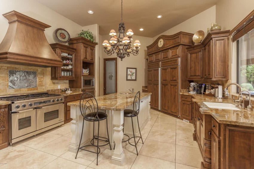 Kitchen with travertine floor tiles and white island