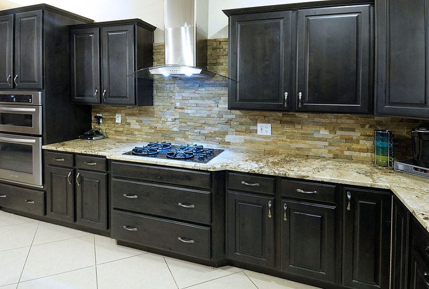 Kitchen with slate backsplash and cabinets with chrome handles