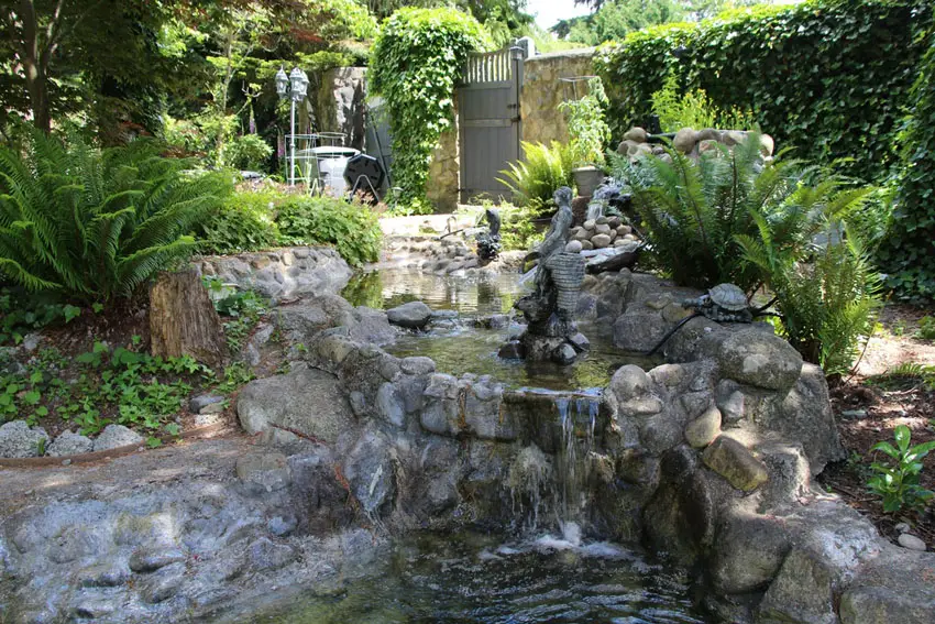 Garden landscaping with stone waterfall and pond