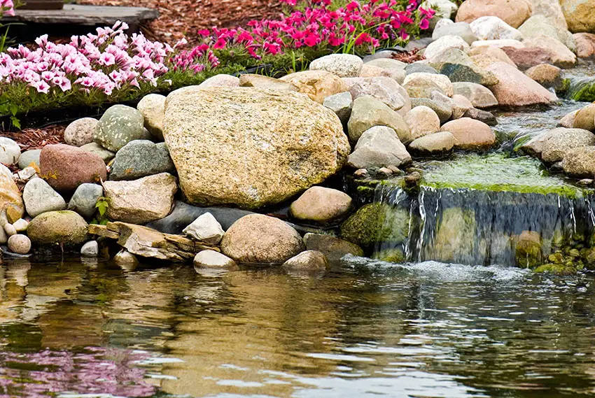 Garden waterfall flowing in to pond