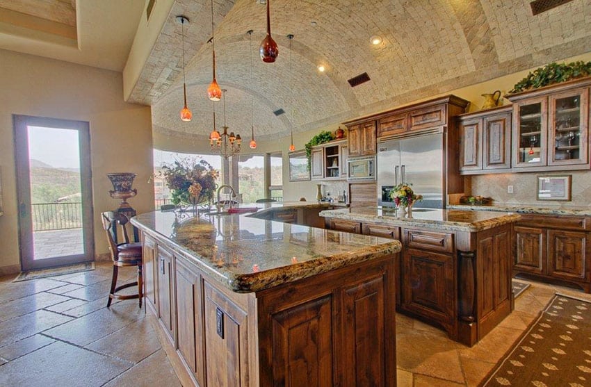 Gorgeous traditional kitchen with arched stone ceiling rustic cabinetry