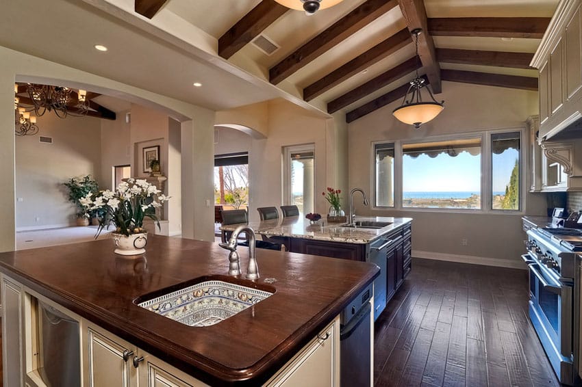 Kitchen with vaulted ceiling and dark wood flooring