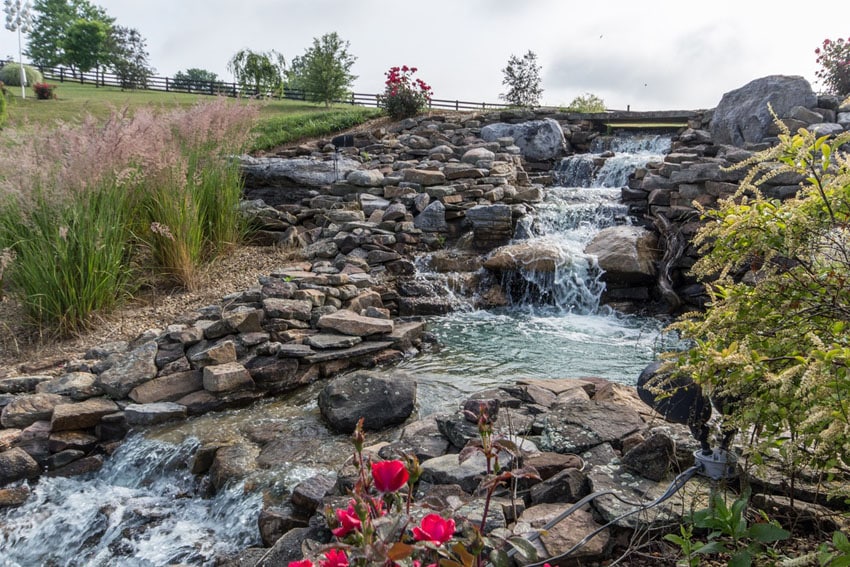 Large stacked stone waterfall in garden