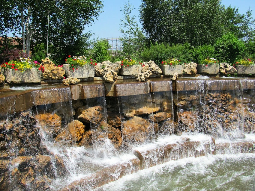 Large waterwall with potted flowers
