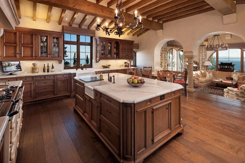 Craftsman kitchen with raised panel cabinets, white marble counters and wood floors