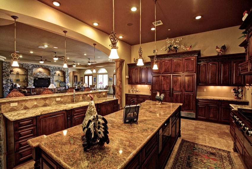 Luxury kitchen with giallo veneziano granite countertops pendant lighting