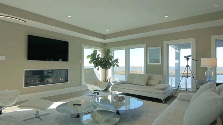 Luxury living room with waterfront views and modern gas fireplace