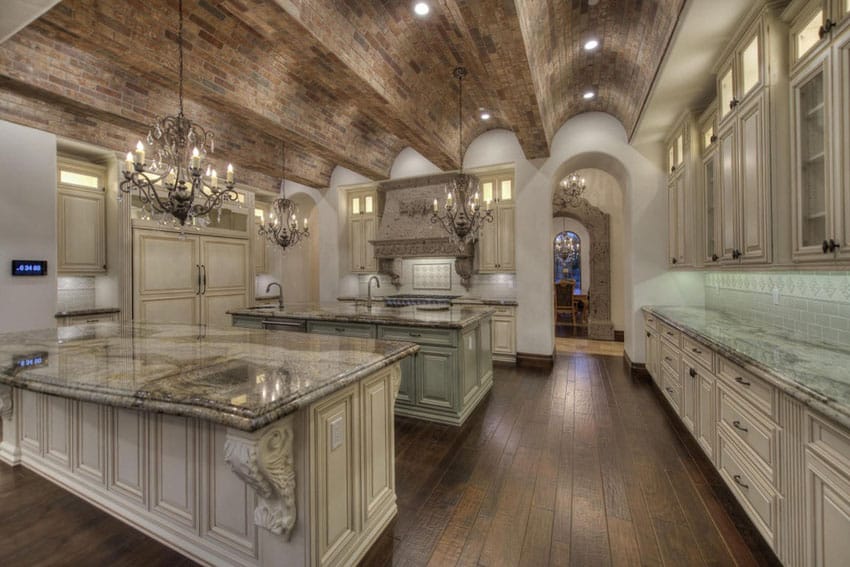 Kitchen with arched brick ceilin, off white cabinetry and crystal chandeliers
