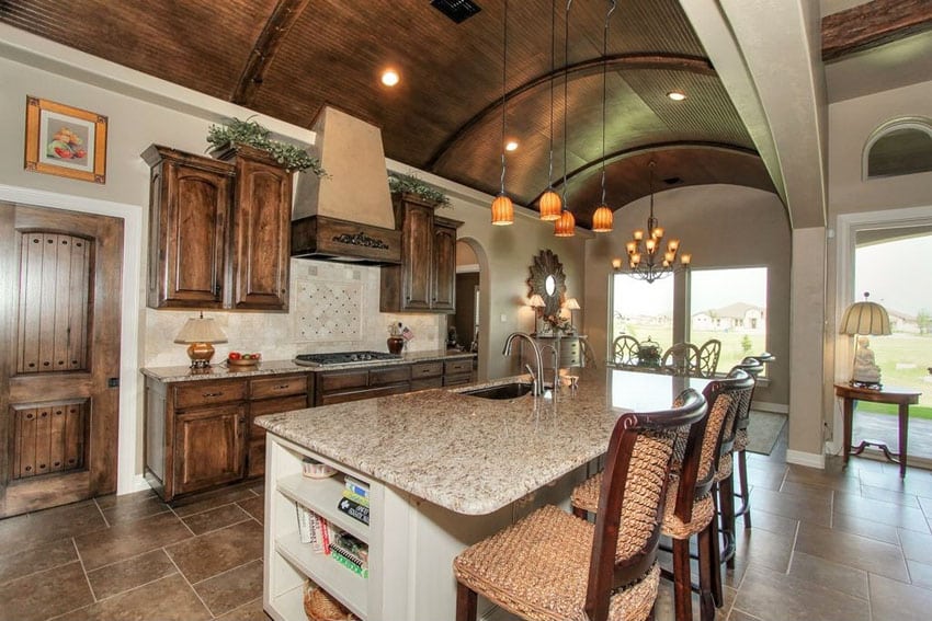 Mediterranean kitchen with blanco tulum granite counter arched wood ceilings