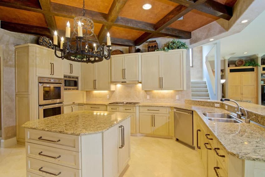 Kitchen with cream cabinets and wagin wheel style chandelier