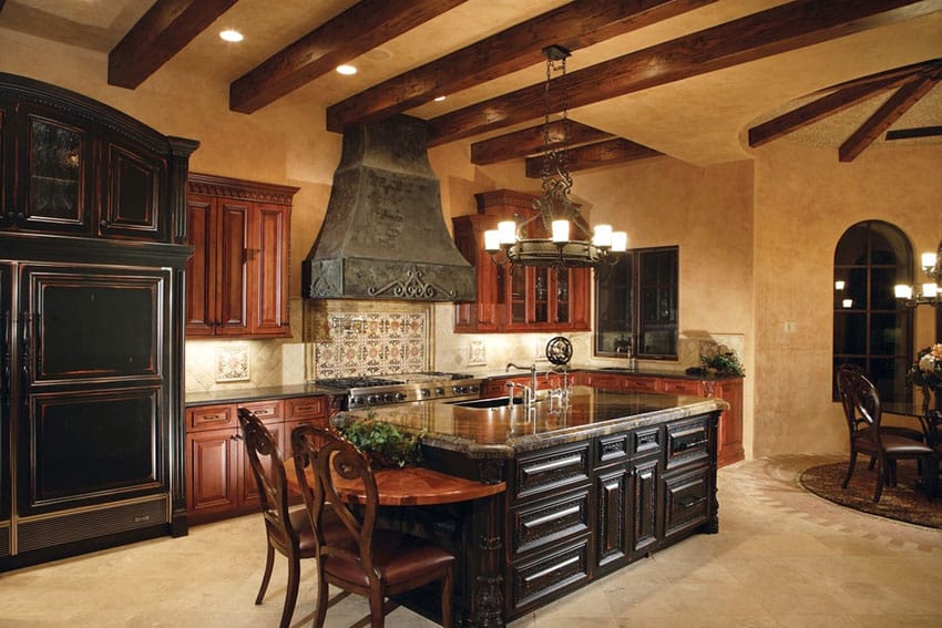 Mediterranean kitchen with dark cabinets island travertine floors and marble counters