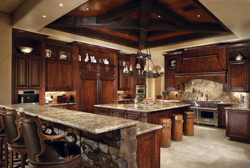 Mediterranean kitchen with juparana arandis granite counters and travertine floor tiles