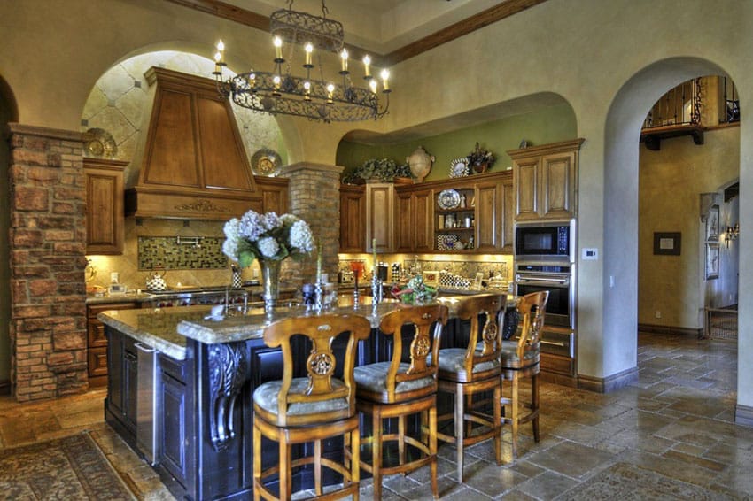Kitchen with medieval style chandelier and wood chairs with upholstered seating