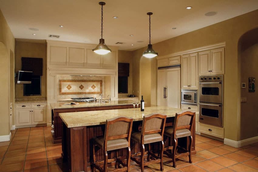 Mediterranean kitchen with terra cotta flooring and bianco romano granite counters