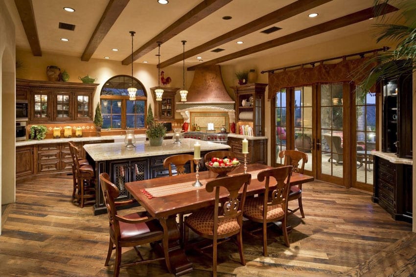 Mediterranean kitchen with wood flooring granite counters and raised wood cabinets